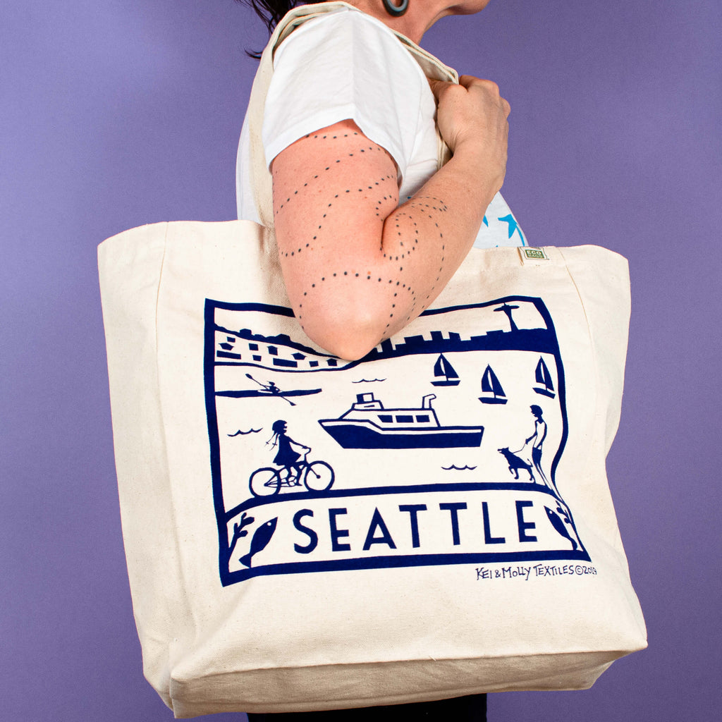 Kei & Molly Tote Bag with Seattle Design in Navy Held by Model