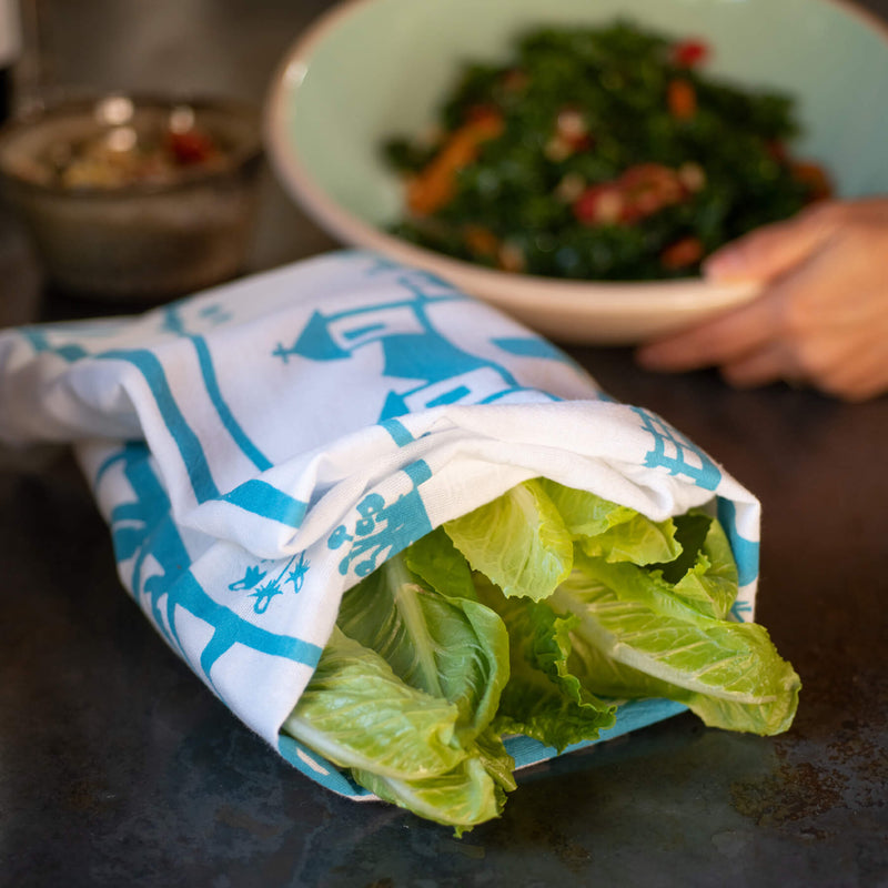 This photo shows a Kei & Molly Vinyard flour sack dish towel being used to dry romaine lettuce.
