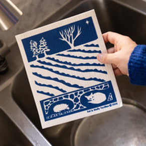 Kei & Molly Textiles Winter Night Sponge Cloth being held over the sink