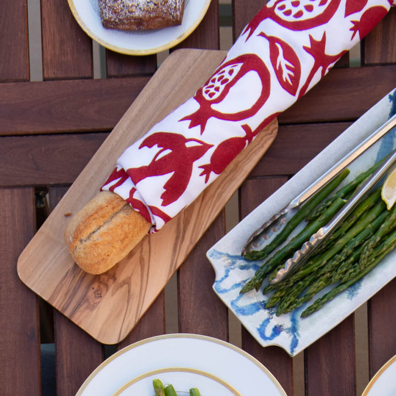 This photo shows a Kei & Molly Pomegranate towel wrapped around a baguette for serving.