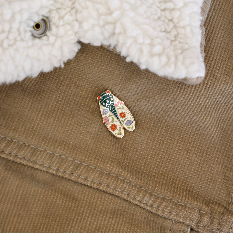 Cicada enamel pin designed by Justine Gilbuena