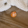 Orange cat enamel pin designed by Justine Gilbuena