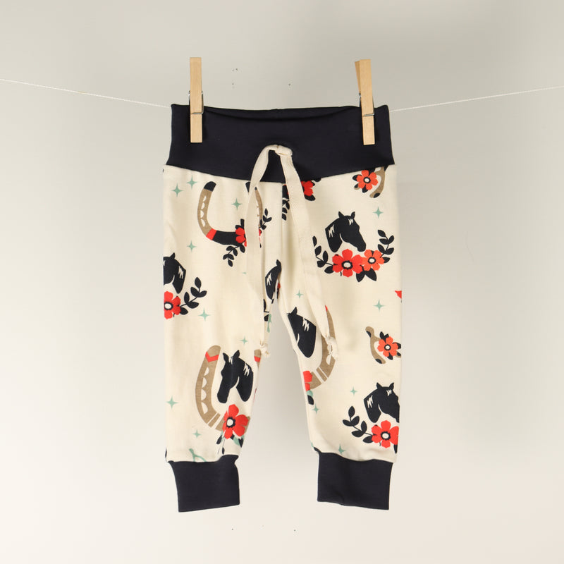 Baby pants by Kinder Sprout: horse shoes and horses, front view