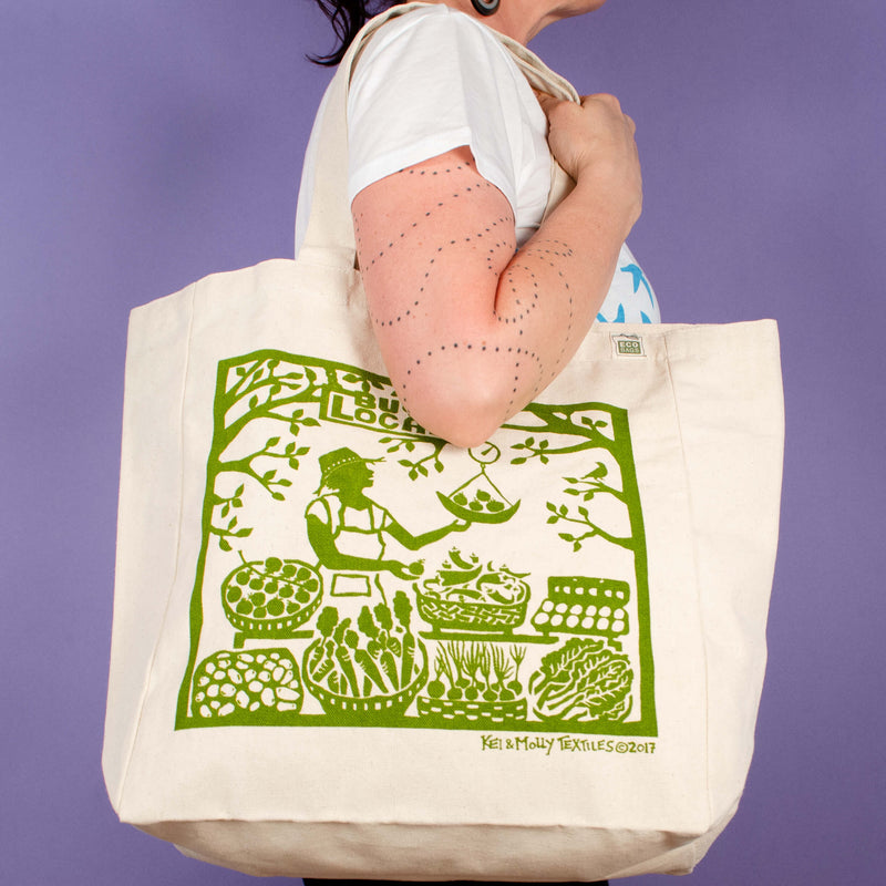 Kei & Molly Tote Bag with Buy Local Design in Green Held by Model