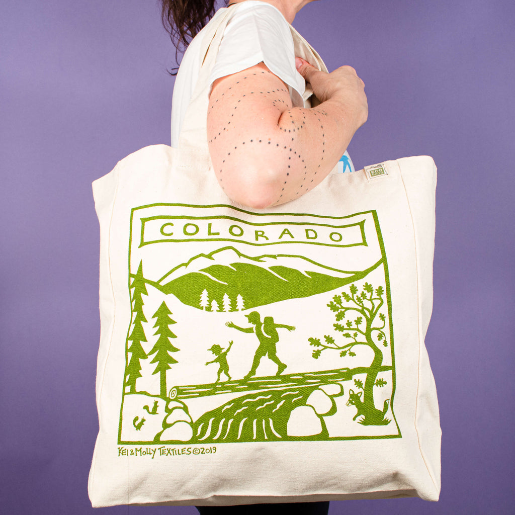 Kei & Molly Tote Bag with Colorado Design in Green Held by Model