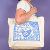Kei & Molly Tote Bag with Grow Local Design in Sky Blue Held by Model