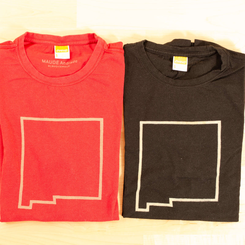 Maude Andrade Bamboo t-shirts in red and black with New Mexico state outline, shown here folded.