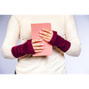 B. B Sheep cashmere fingerless gloves in dark maroon. Model holding a notebook.
