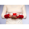 B. B Sheep cashmere fingerless gloves in red. Model holding a tea cup.